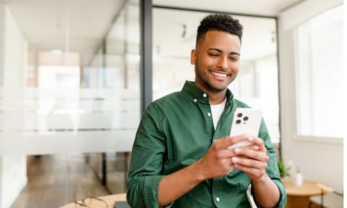 Young businessman smiling at phone