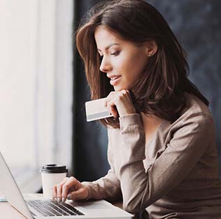 business woman on laptop with credit card