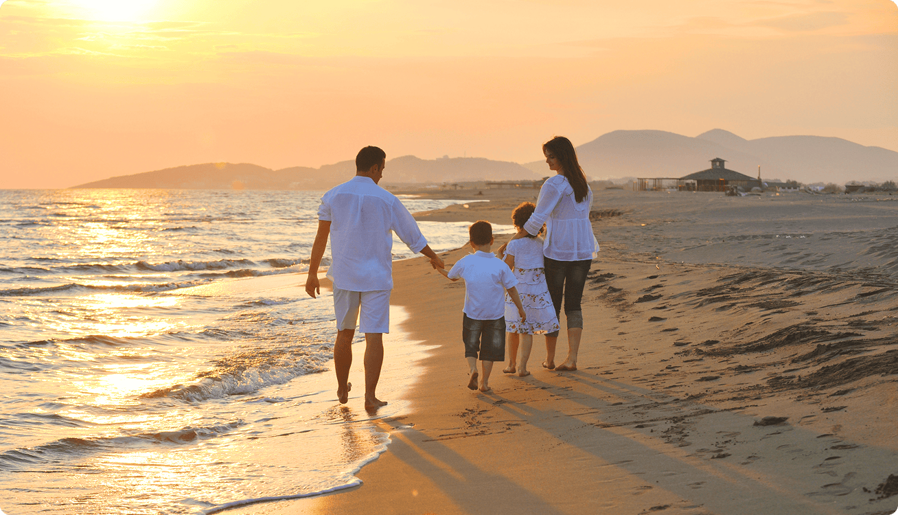 Family walking down beach