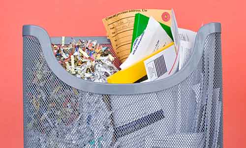 Shredding personal documents for security purposes.