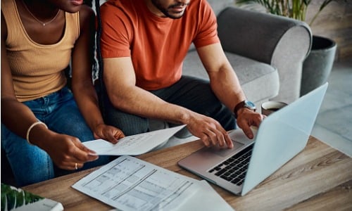 Couple sitting using laptop for finances