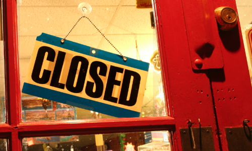 closed sign hanging from a door