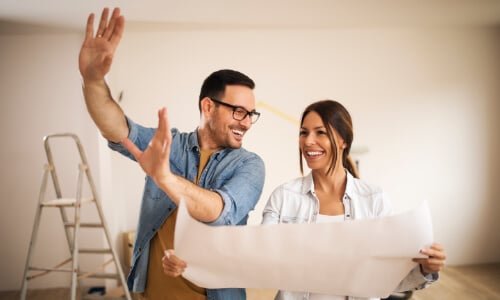 Couple looking at floor plans together