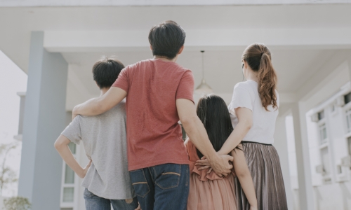 A family standing in their new home