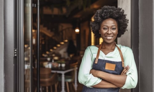 A business owner standing in front door