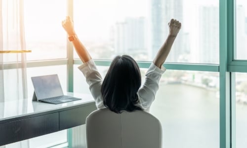 A person sitting in a office celebrating