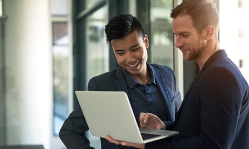 Two employees discussing a business deal