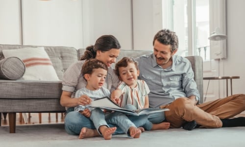 A family spending time together reading a book