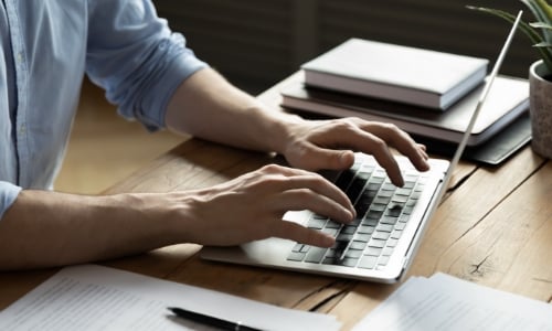 A person typing on a laptop