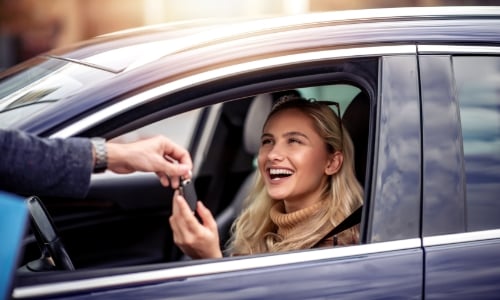 A person getting the keys to their new car