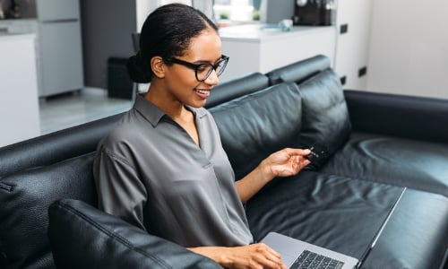 A person shopping online with a credit card