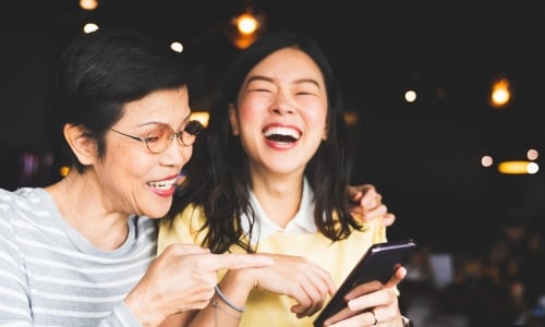 A parent and child laughing together