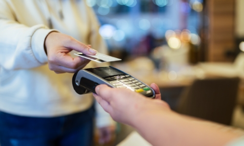 A person paying for a purchase with a credit card