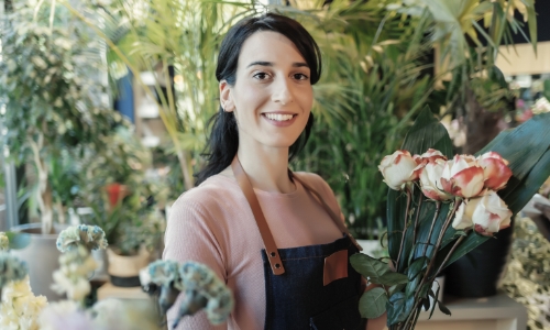 A business owner standing in a flower shop