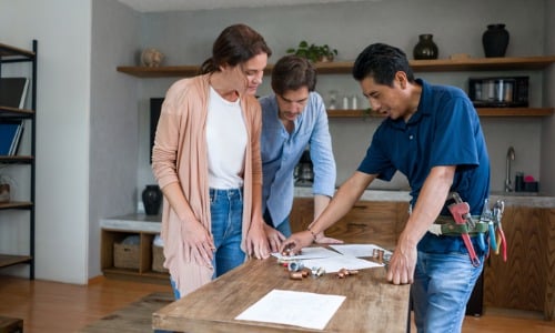 Contractor talking to clients about home repairs