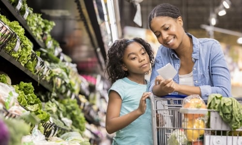 A parent and child grocery shopping