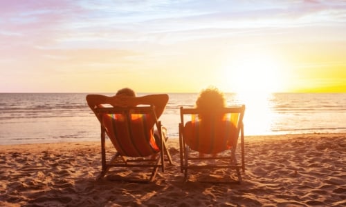 A retired couple relaxing on the beach