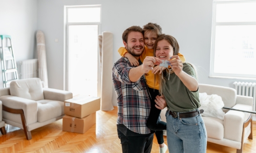 A family holding keys to their new home