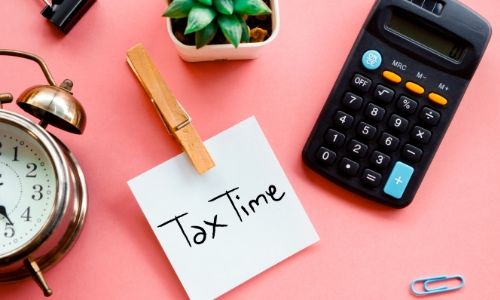 A sticky note with "Tax Time" written on it