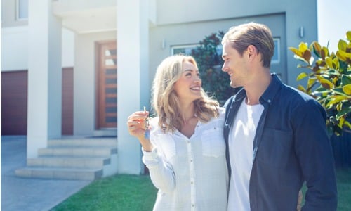 Young couple holding their new house key