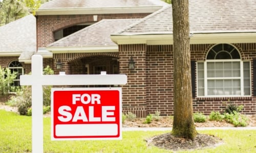 House with For Sale Sign in front