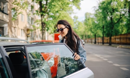 A person getting into a car to get a ride