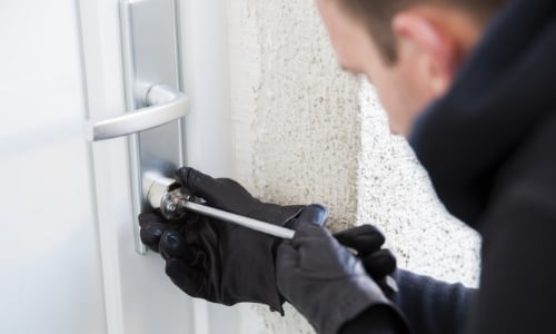 A burglar breaking into someone's home