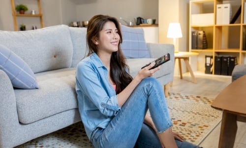 A person sitting in their home watching tv