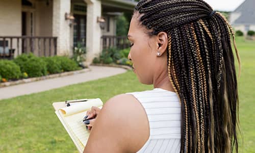 Woman conducts a property evaluation.