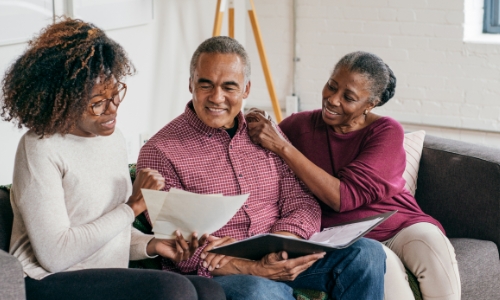 A retired couple and their child discussing last will and testament options