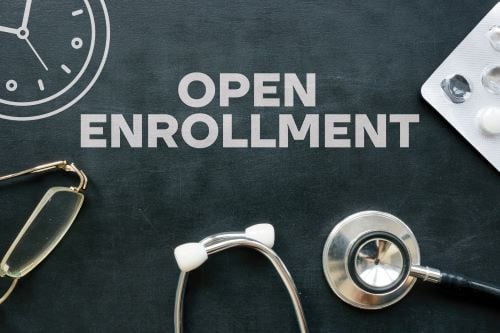 Open enrollment healthcare forms in front of a doctor.