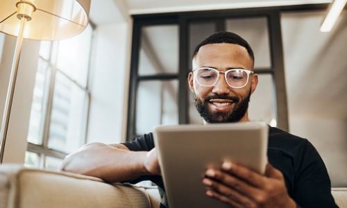 Man looking at online banking on tablet