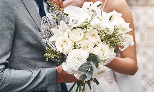 Bride and groom holding a bouquet