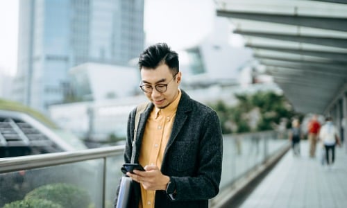 Man using smartphone while walking