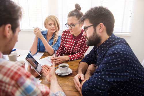 Co-workers gathered around a table