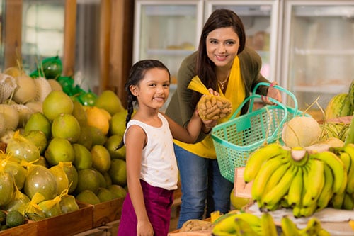 A parent and child grocery shopping