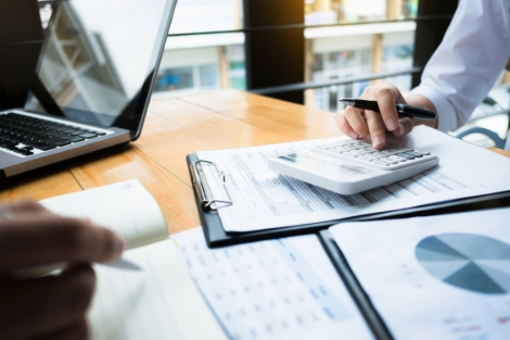 Business owner using a calculator in a meeting