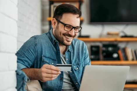 A guy using his credit card to shop online