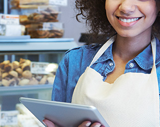 Woman in apron inside a bakery