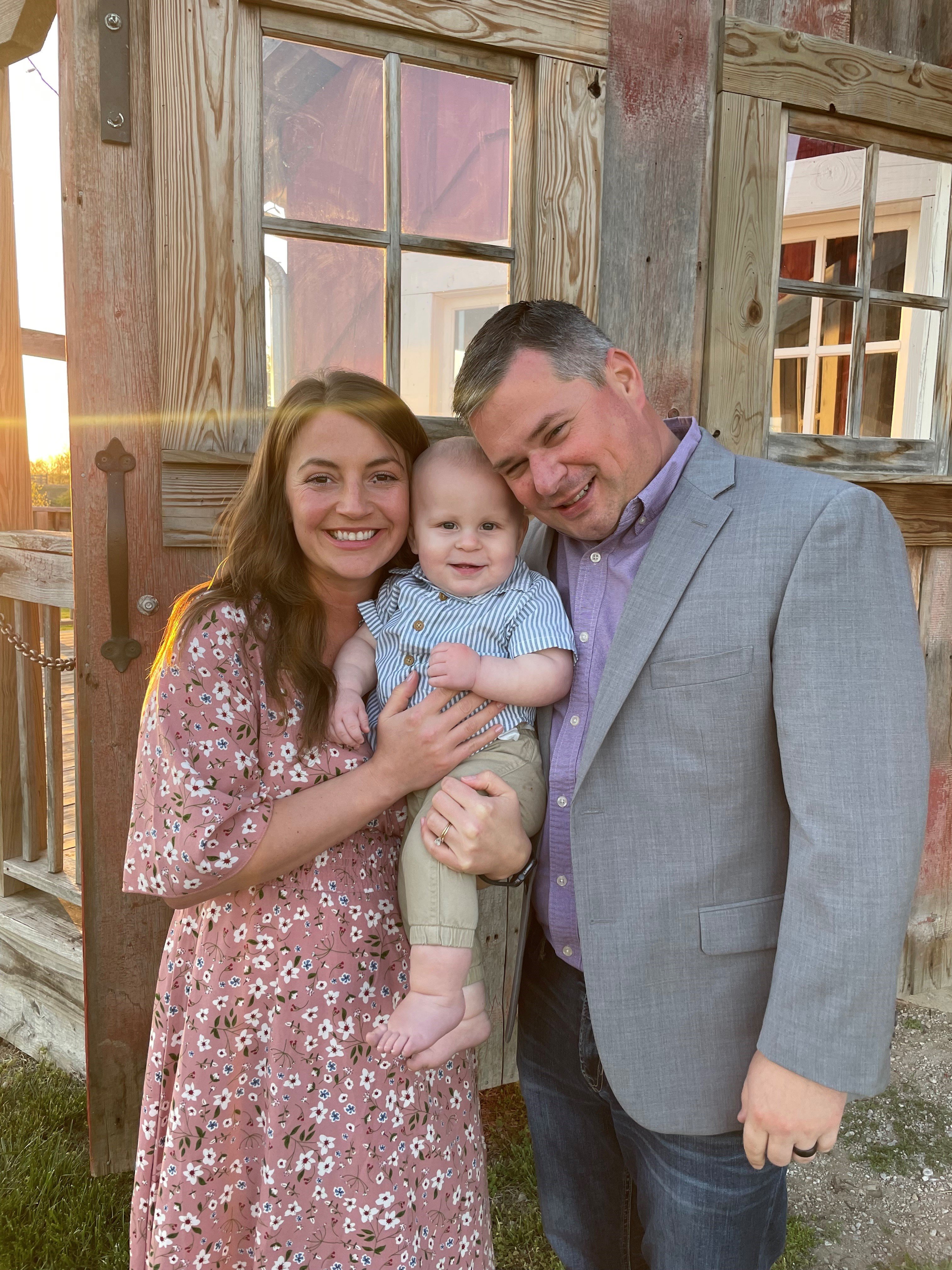 Greg standing with family