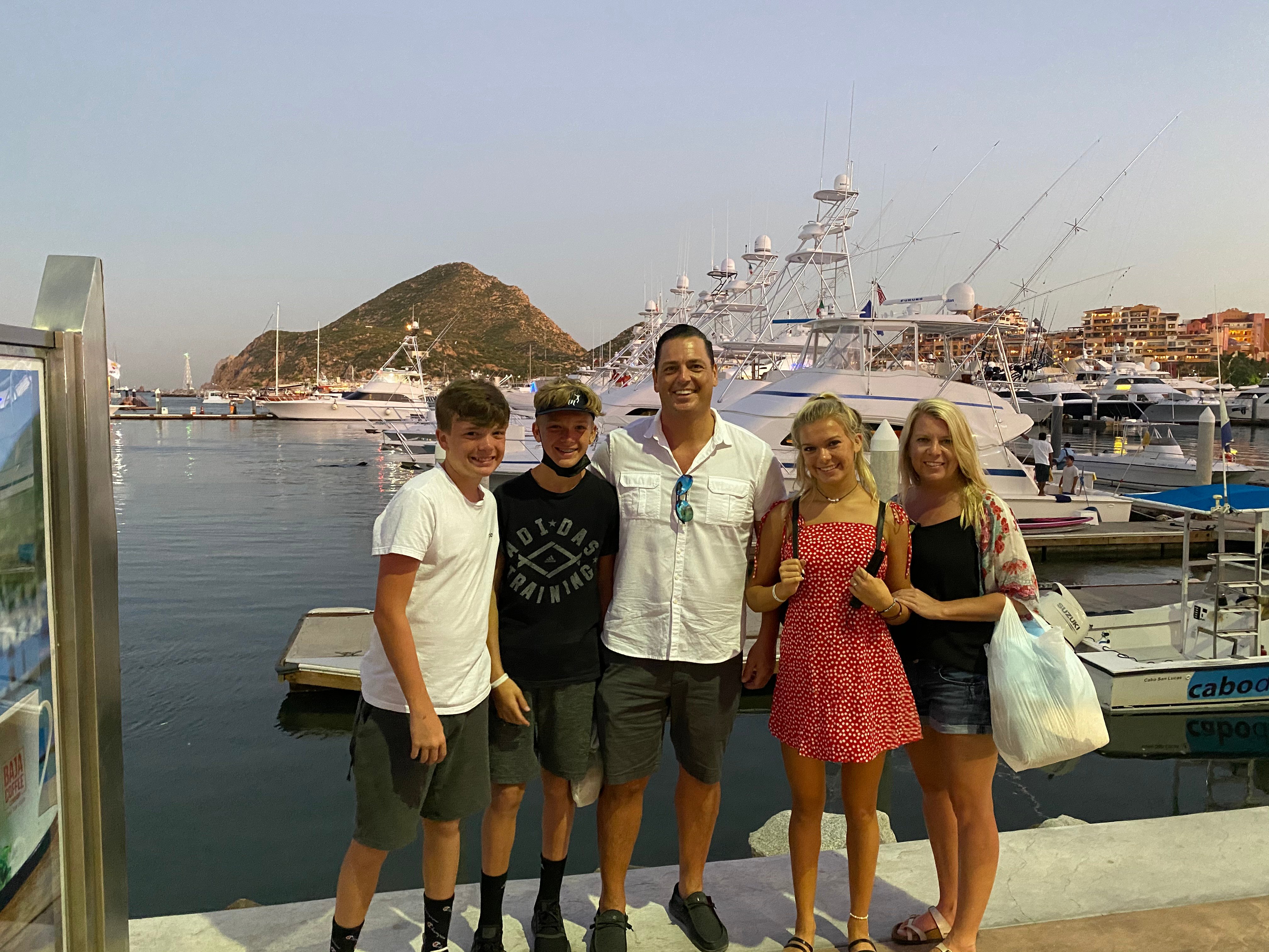Matthew with his family at a dock