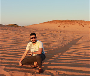 Photo of Ray crouching on sandy dunes during sunset