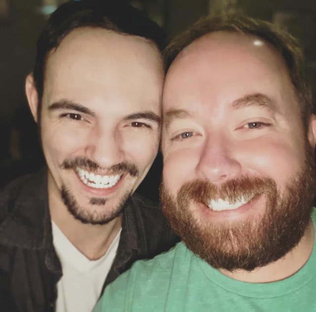 Scott taking a selfie with a guy