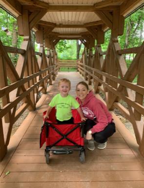 Darla and son taking picture on a bridge