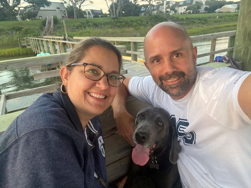 Scott, wife and dog by water