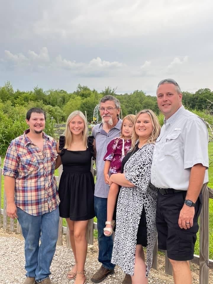 Tamara standing with her family