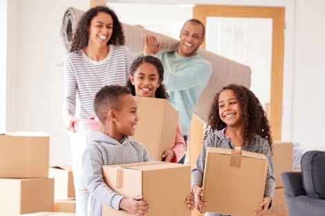 A family carrying boxes