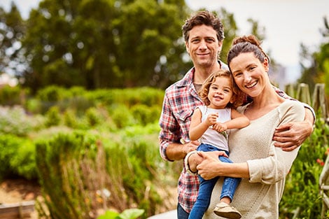 Family standing in a garden