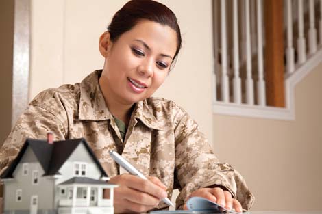 Woman in military gear writing on paper