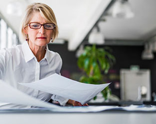 Woman arranging papers on her desk